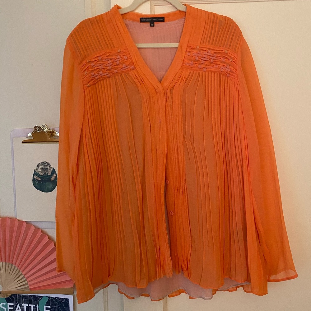 Coral pleated button-up blouse